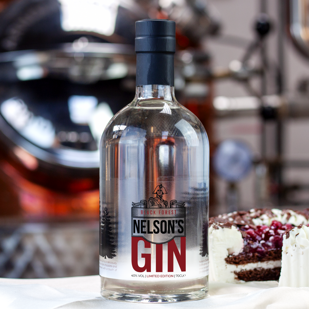 Nelson's Black Forest Gin next to Black Forest Gateau in front of Nelson's still, Victory.