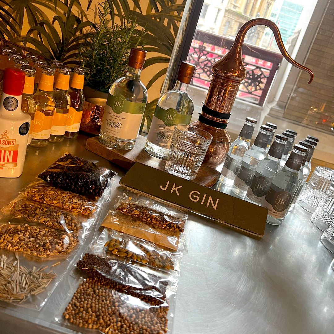 Botanicals laid out in front of JK Gin bottle.
