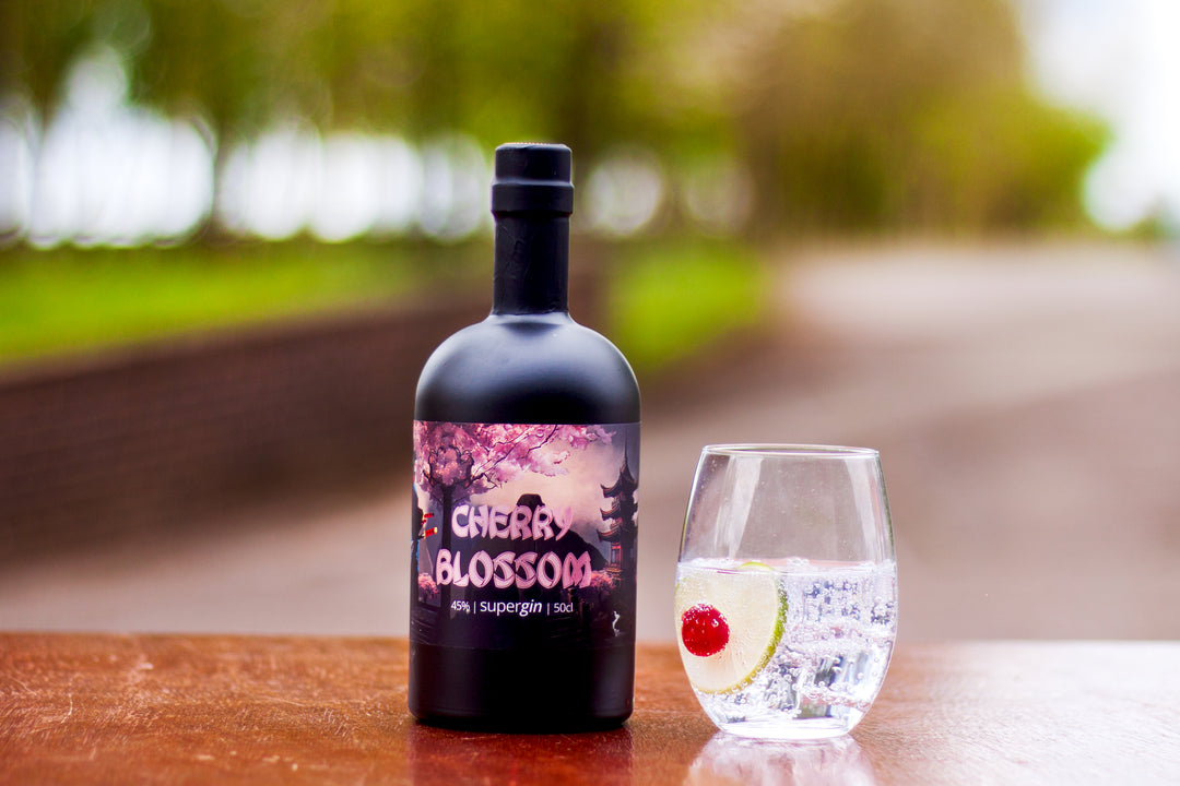 Roy Wood's Cherry Blossom Supergin with perfect serve. Set outside with blurred landscape.
