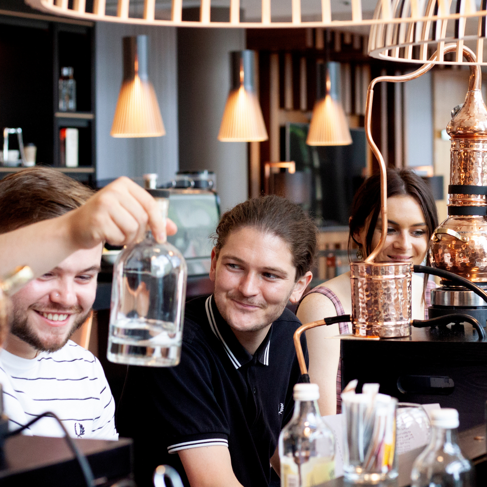 Man swirling gin distilled at Nelson's Gin, Rum & Vodka School.