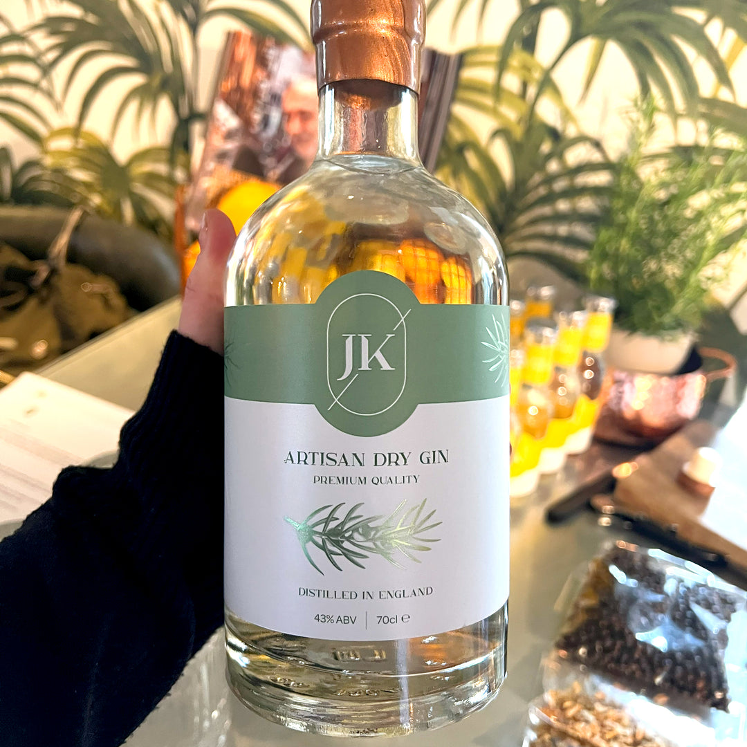 Hand holding JK Gin bottle.