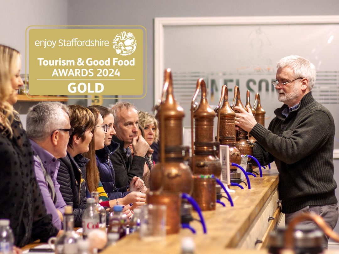 Full class at Nelson's Gin, Vodka & Rum School with presenter securing miniature still. Award logo in top left hand corner.