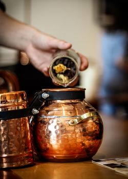Pouring botanicals into micro still at Nelson's Gin & Vodka School