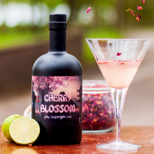 Roy Wood's Cherry Blossom Supergin with The Cherry Blossom cocktail. Blurred landscape background.