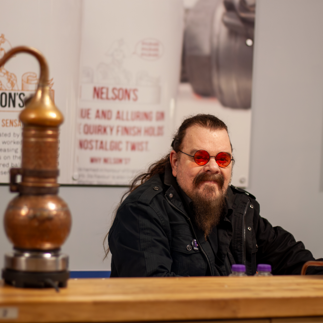 RoyWood sat in front of micro still at Nelson's Gin, Vodka & Rum School making his Cherry Blossom Supergin.