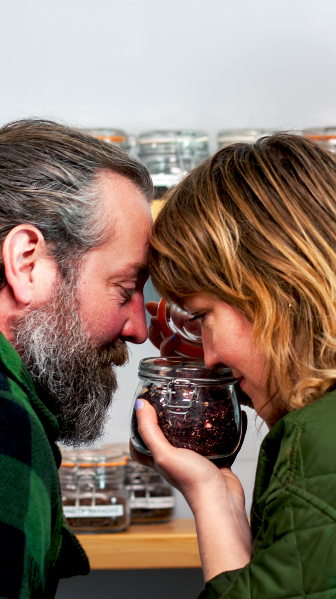 Engaged couple smelling botanicals at Nelson's Gin, Vodka & Rum School portrait. 